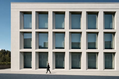 A stone building facade with a grid of windows